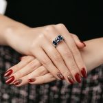 woman jewelery concept. woman hands close up wearing rings, earrings and necklace modern accessories elegant life style.